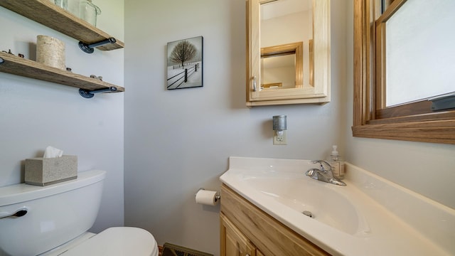 bathroom featuring toilet and vanity