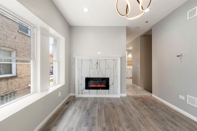 4819 W Superior St, Chicago, IL 60644 - unfurnished living room featuring wood finished floors, a fireplace, baseboards, and recessed lighting