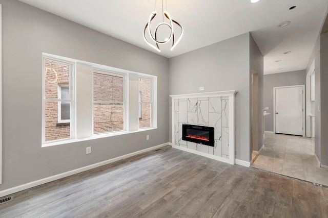 4819 W Superior St, Chicago, IL 60644 - unfurnished living room with wood finished floors, a fireplace, and baseboards