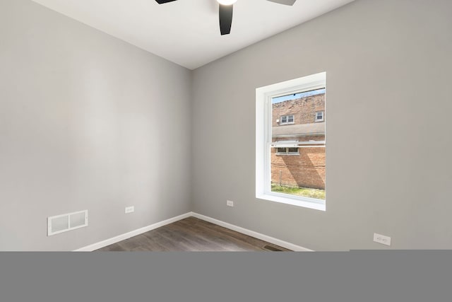 4819 W Superior St, Chicago, IL 60644 - spare room featuring dark wood-style flooring, baseboards, and ceiling fan