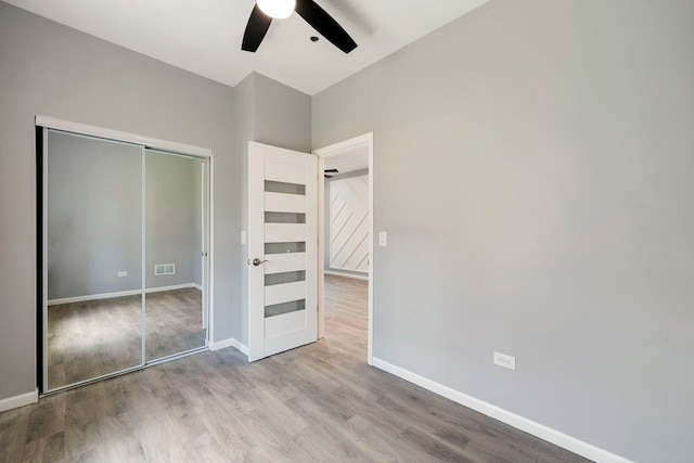 4819 W Superior St, Chicago, IL 60644 - unfurnished bedroom with wood finished floors, baseboards, and a closet