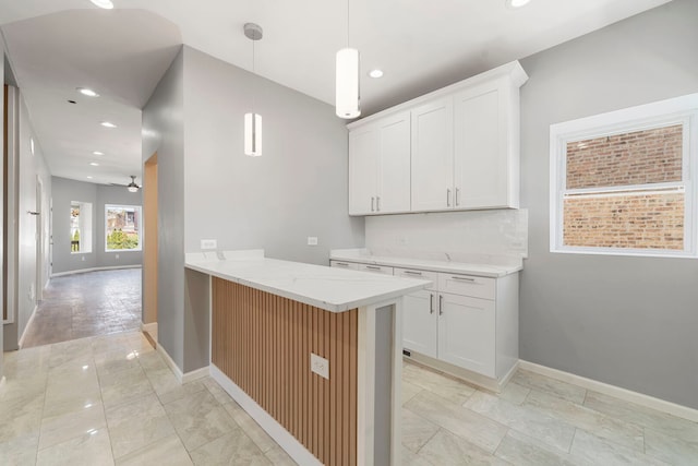 4819 W Superior St, Chicago, IL 60644 - kitchen featuring recessed lighting, a ceiling fan, decorative light fixtures, baseboards, and light stone countertops