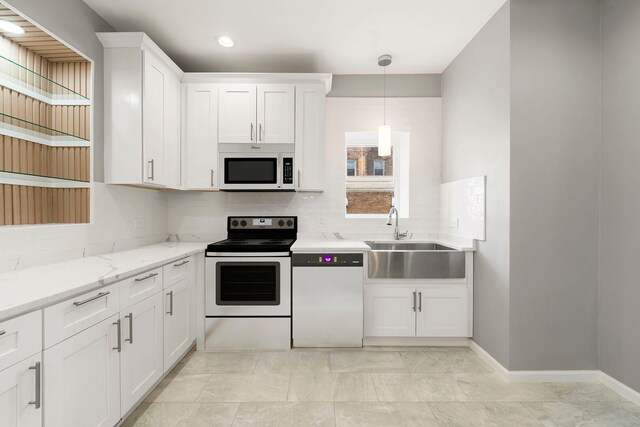 4819 W Superior St, Chicago, IL 60644 - kitchen with white appliances, a sink, tasteful backsplash, white cabinetry, and recessed lighting