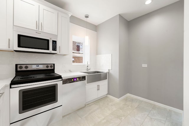 4819 W Superior St, Chicago, IL 60644 - kitchen featuring range with electric cooktop, white microwave, dishwashing machine, a sink, and decorative backsplash