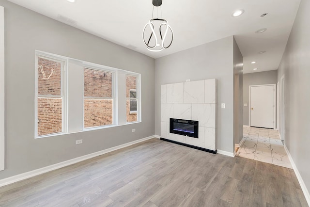 4819 W Superior St, Chicago, IL 60644 - unfurnished living room featuring light wood finished floors, recessed lighting, a fireplace, and baseboards