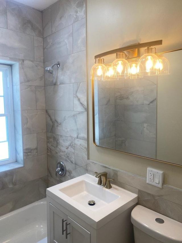 4819 W Superior St, Chicago, IL 60644 - bathroom featuring tile walls, tasteful backsplash, healthy amount of natural light, toilet, and vanity