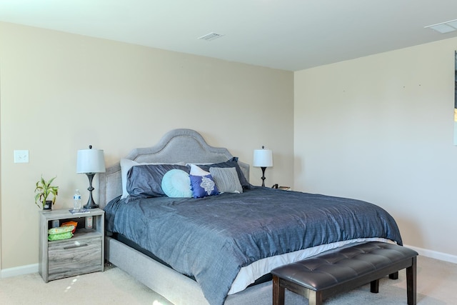 carpeted bedroom with visible vents and baseboards