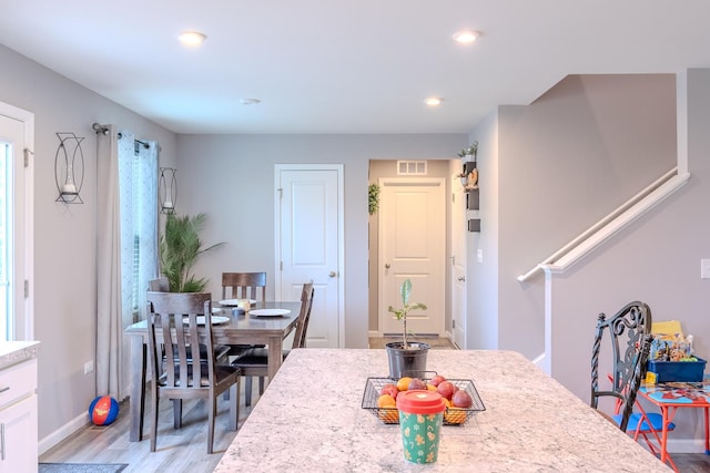 dining area with stairway, light wood-style flooring, baseboards, visible vents, and recessed lighting