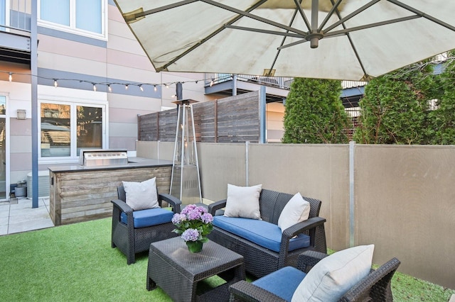 view of patio / terrace featuring fence, grilling area, an outdoor living space, and area for grilling