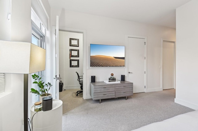 carpeted bedroom featuring baseboards