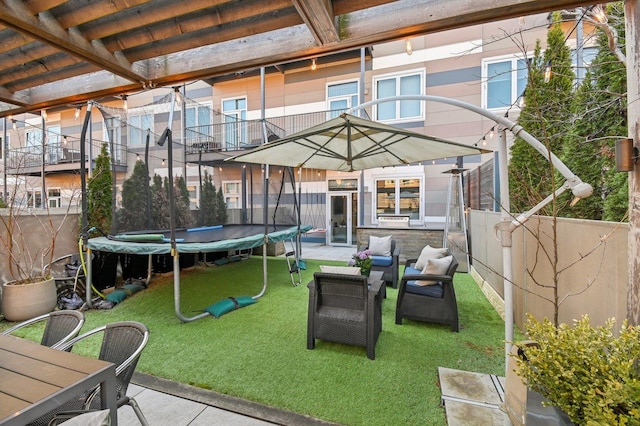 view of patio / terrace with fence and a trampoline