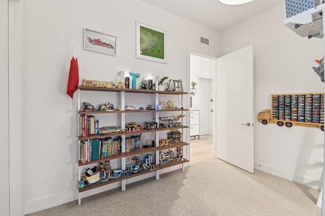 interior space with carpet flooring, baseboards, and visible vents
