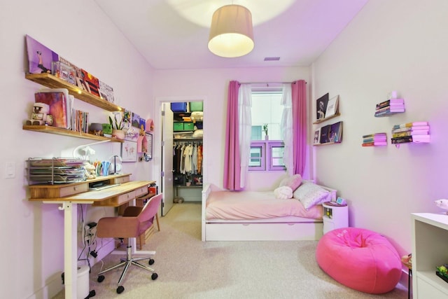 bedroom with visible vents, carpet, a closet, and a spacious closet