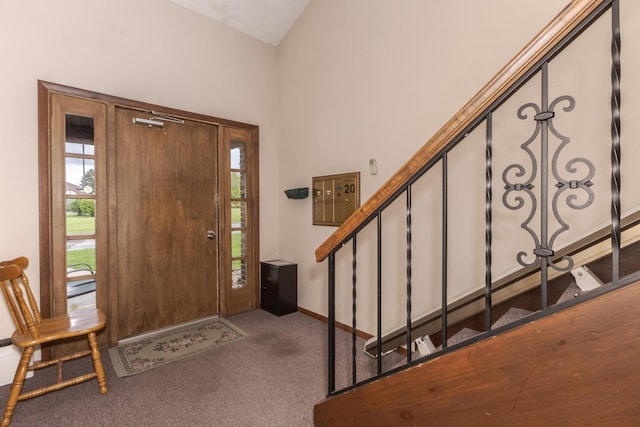 entrance foyer featuring baseboards, carpet flooring, stairs, and vaulted ceiling