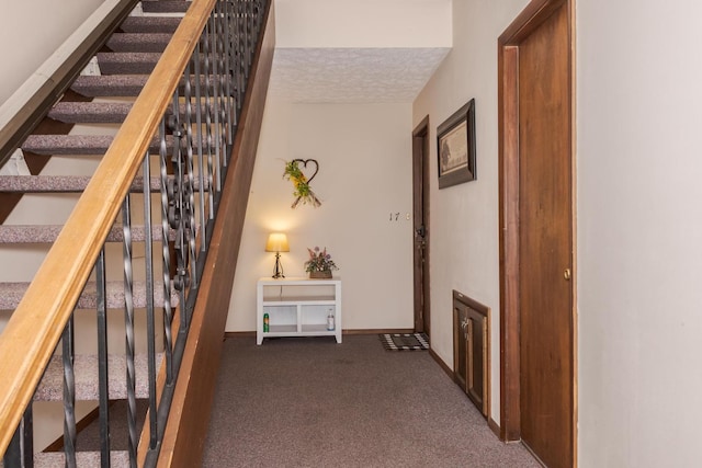 corridor featuring stairway, baseboards, and carpet