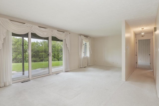unfurnished room with carpet floors, baseboards, and visible vents
