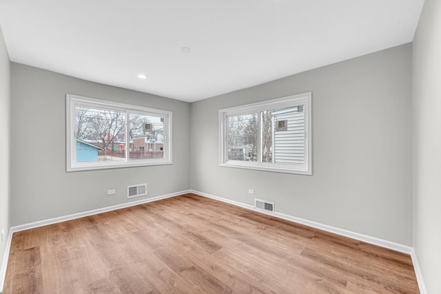 211 W 112th Pl, Chicago, IL 60628 - empty room featuring baseboards, light wood-style floors, and visible vents