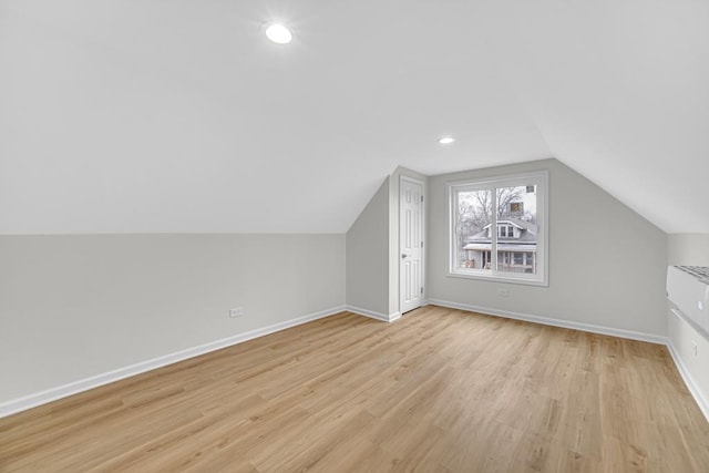 211 W 112th Pl, Chicago, IL 60628 - additional living space with vaulted ceiling, baseboards, recessed lighting, and light wood-style floors