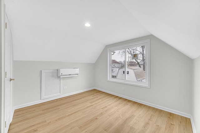 211 W 112th Pl, Chicago, IL 60628 - bonus room featuring baseboards, lofted ceiling, light wood-type flooring, and a wall unit AC