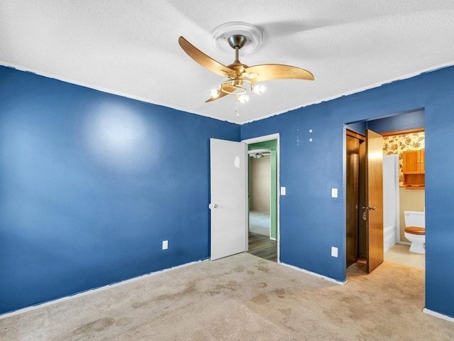 1045 Briarcliff Dr, Rantoul, IL 61866 - unfurnished bedroom with carpet, a textured ceiling, ceiling fan, and baseboards