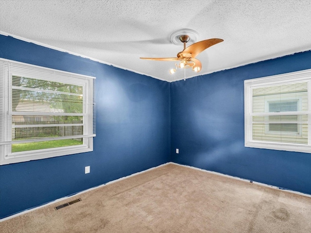 1045 Briarcliff Dr, Rantoul, IL 61866 - empty room with carpet floors, ceiling fan, a textured ceiling, and baseboards