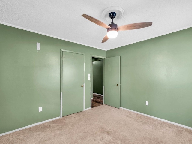 1045 Briarcliff Dr, Rantoul, IL 61866 - unfurnished bedroom featuring carpet, baseboards, a ceiling fan, a closet, and crown molding
