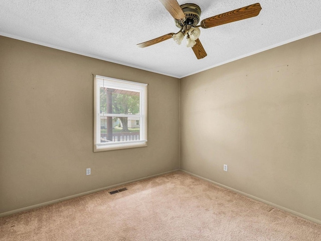 1045 Briarcliff Dr, Rantoul, IL 61866 - unfurnished room featuring carpet flooring, a textured ceiling, a ceiling fan, and baseboards