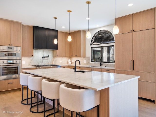 kitchen with decorative backsplash, a sink, recessed lighting, and appliances with stainless steel finishes