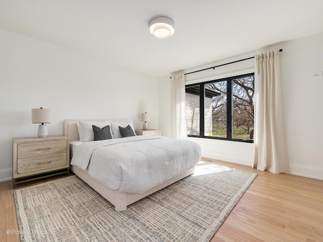 bedroom featuring baseboards and light wood-type flooring