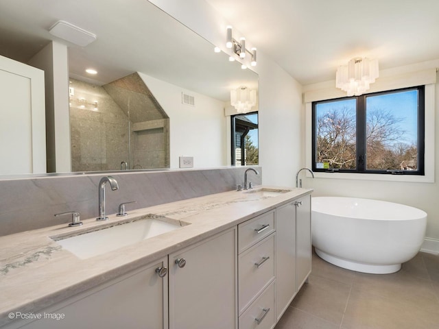 full bath featuring tile patterned floors, visible vents, a sink, and a notable chandelier