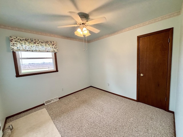 2445 Graham Rd, Belvidere, IL 61008 - spare room featuring ceiling fan, light carpet, visible vents, and baseboards
