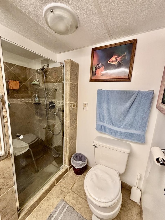 2445 Graham Rd, Belvidere, IL 61008 - bathroom featuring a stall shower, tile patterned floors, a textured ceiling, and toilet