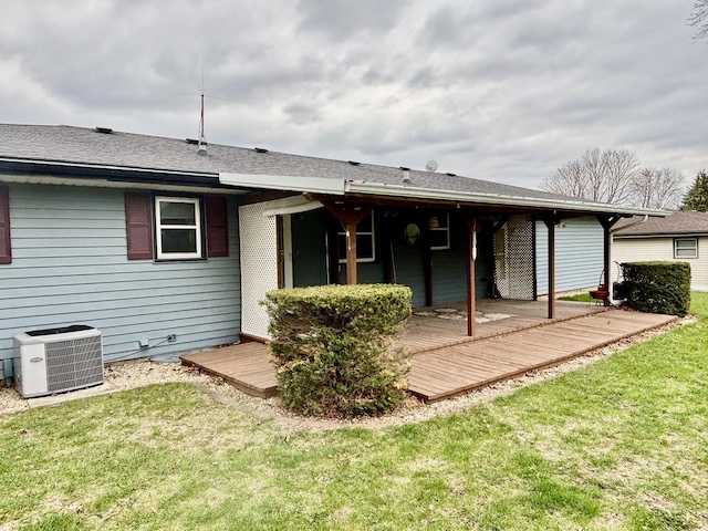 2445 Graham Rd, Belvidere, IL 61008 - back of house with a deck, a yard, and central AC unit