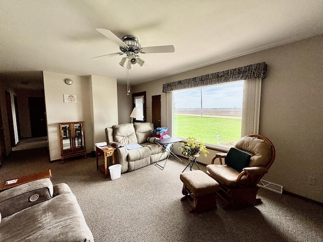 2445 Graham Rd, Belvidere, IL 61008 - carpeted living area with a ceiling fan and baseboards
