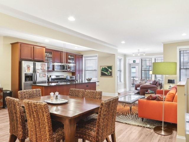 dining area with light wood finished floors, baseboards, recessed lighting, and ornamental molding