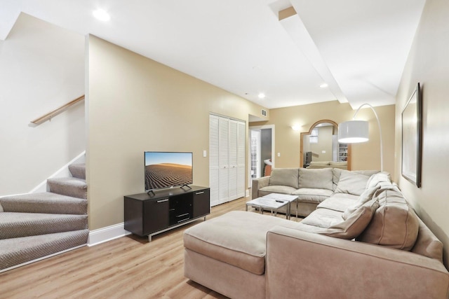 bedroom with a closet, ceiling fan, wood finished floors, and baseboards