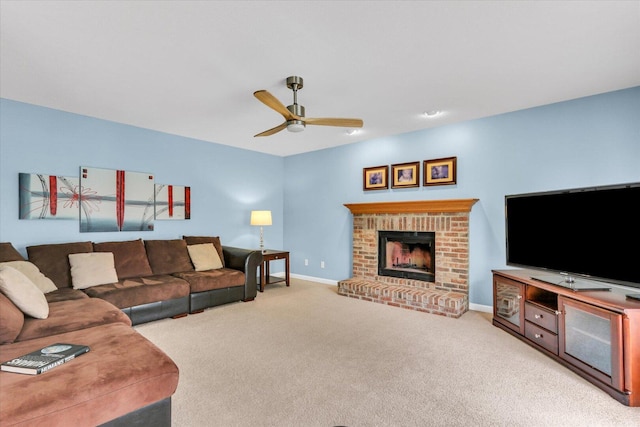 carpeted living room with baseboards, a fireplace, and a ceiling fan