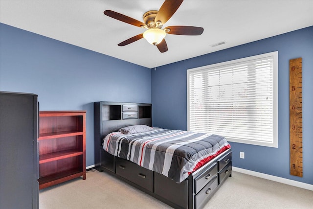 bedroom featuring carpet floors, a ceiling fan, baseboards, and visible vents