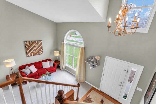 entrance foyer with baseboards, a notable chandelier, and a healthy amount of sunlight