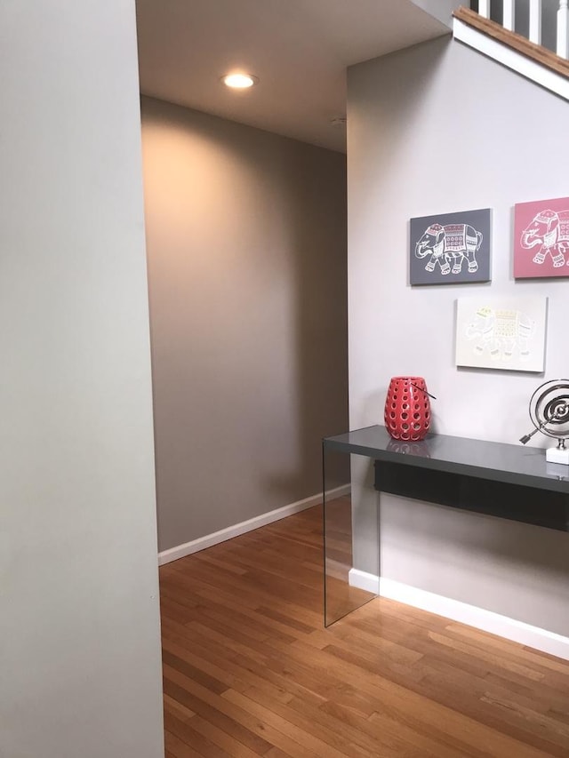 hall with baseboards, recessed lighting, and wood finished floors