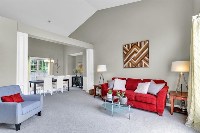 carpeted living area featuring a notable chandelier and high vaulted ceiling