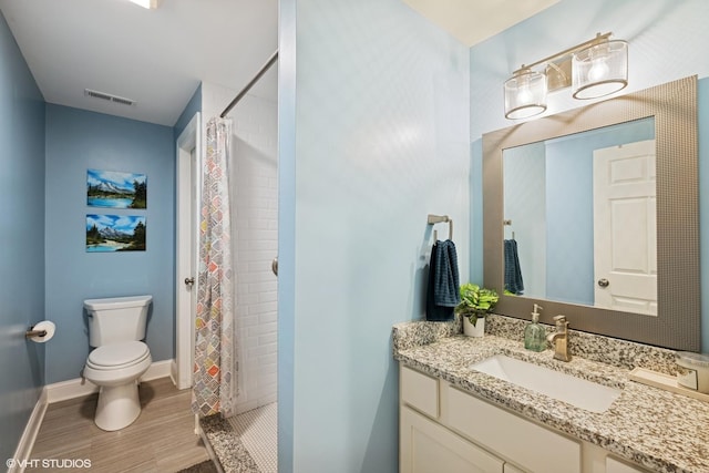 full bathroom featuring wood finished floors, visible vents, toilet, and tiled shower