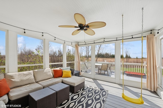 sunroom with an outdoor hangout area, ceiling fan, and a healthy amount of sunlight