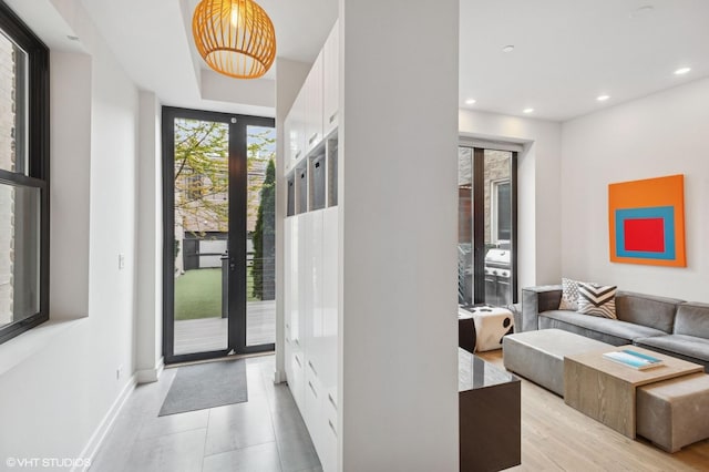 entryway with baseboards, light tile patterned floors, and recessed lighting