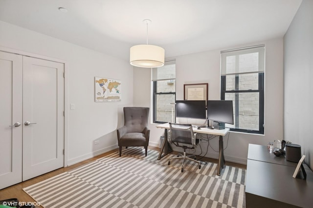 office featuring baseboards and wood finished floors