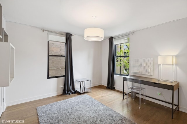 office area with wood finished floors and baseboards