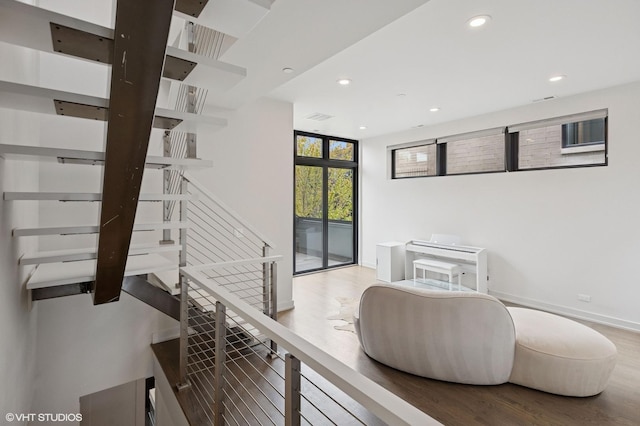 interior space with recessed lighting, baseboards, and wood finished floors