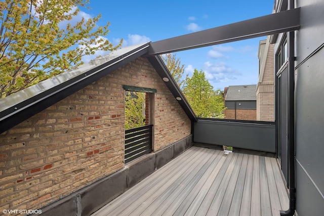 exterior space featuring brick siding and a balcony