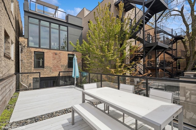 deck with stairway and outdoor dining area