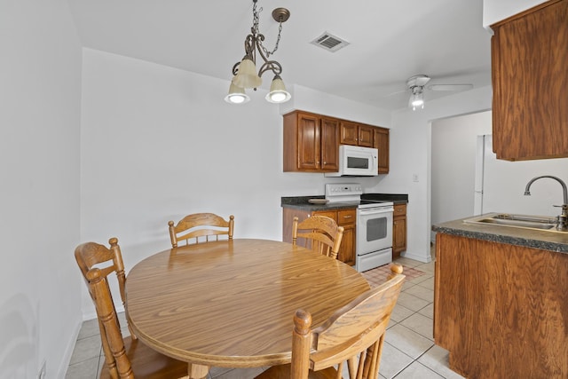 6135 W 94th St Unit C5, Oak Lawn, IL 60453 - kitchen featuring white appliances, a sink, light tile patterned floors, dark countertops, and a ceiling fan